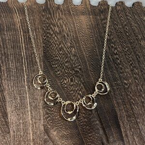 Gold costume necklace with swirls